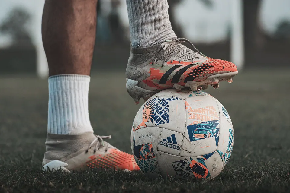 A boot meeting the ball in a close football training drill